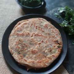 A picture of Spicy Onion Paratha With Spicy Coriander Chutney.