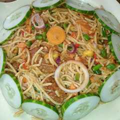A picture of Pasta with stir fried vegetables and beef.