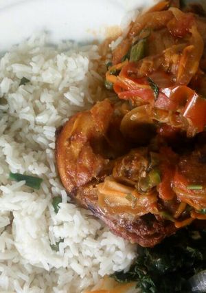 A picture of Chicken with white Rice and Veggies.