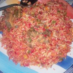 A picture of Coloured fried rice wiz pepper meat.