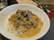 A picture of beef stroganoff with rice