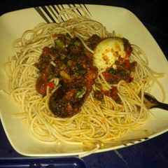 A picture of Spaggetti and vegetable sauce.