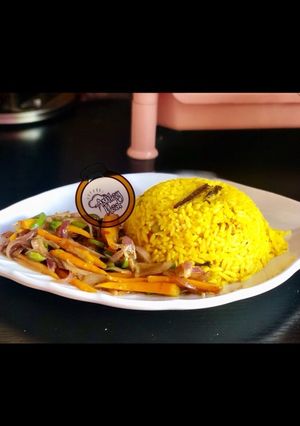 A picture of Yellow rice with stir vegetables.