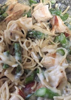 A picture of Chicken, asparagus with angel hair pasta.