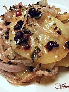 Una foto de Patatas confitadas con cebollas al horno