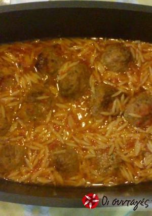 A picture of Giouvetsi with burgers in the Dutch oven.