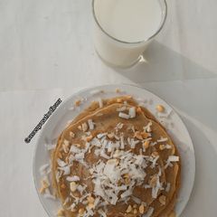 A picture of Coconut pancakes with coconut syrup.