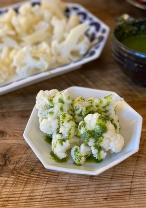 A picture of 🥦 Steamed cauliflower with green sauce.