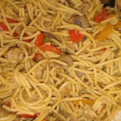 A picture of Chinese noodles with chicken and veggies.