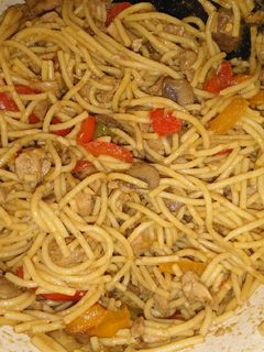 A picture of Chinese noodles with chicken and veggies.