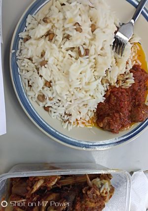 A picture of Rice and beans with tomatoes sauce.