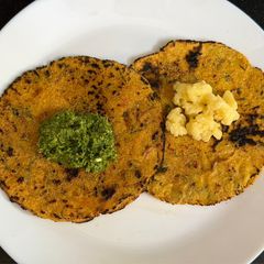 A picture of Soft Makai Rotla Loaded With Veggies (Serve With Green Garlic Chutney & jaggery).