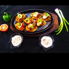 A picture of Schezwan Potato Pizza Bites.