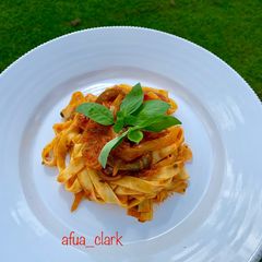 A picture of Tagliatelle with prawns in tomato sauce.