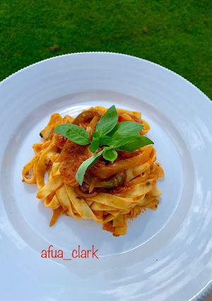 A picture of Tagliatelle with prawns in tomato sauce.