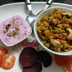 A picture of Delicious Veg Biryani with Beetroot Raita.