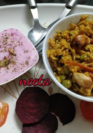 A picture of Delicious Veg Biryani with Beetroot Raita.