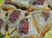 Una foto de tapa de empanadas arabes