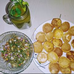 A picture of Golgappa with spicy potato-chana masala and spicy flavored water.