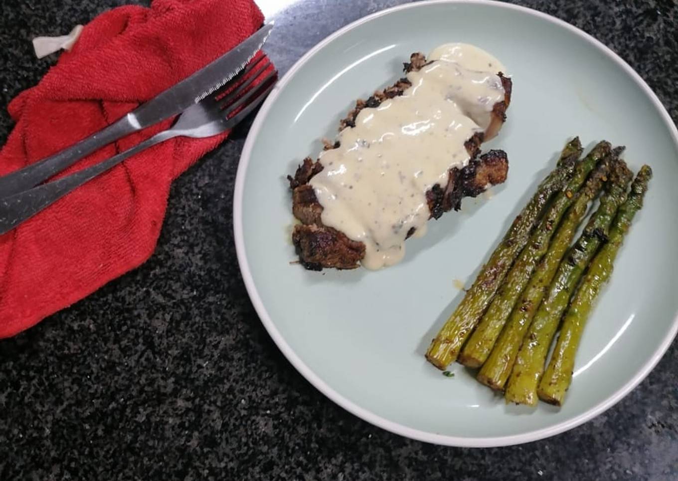 Sirloin steak and goat cheese sauce served with asparagus