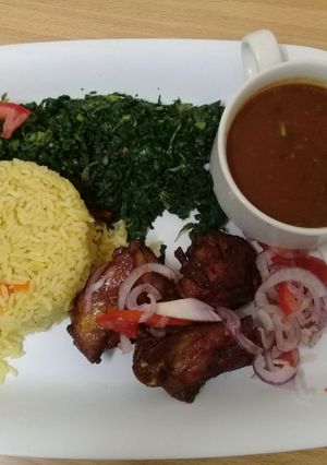 A picture of Steamed Tumeric Rice,pan grilled chicken, Fried spinach and Mixed Vegetable gravy.