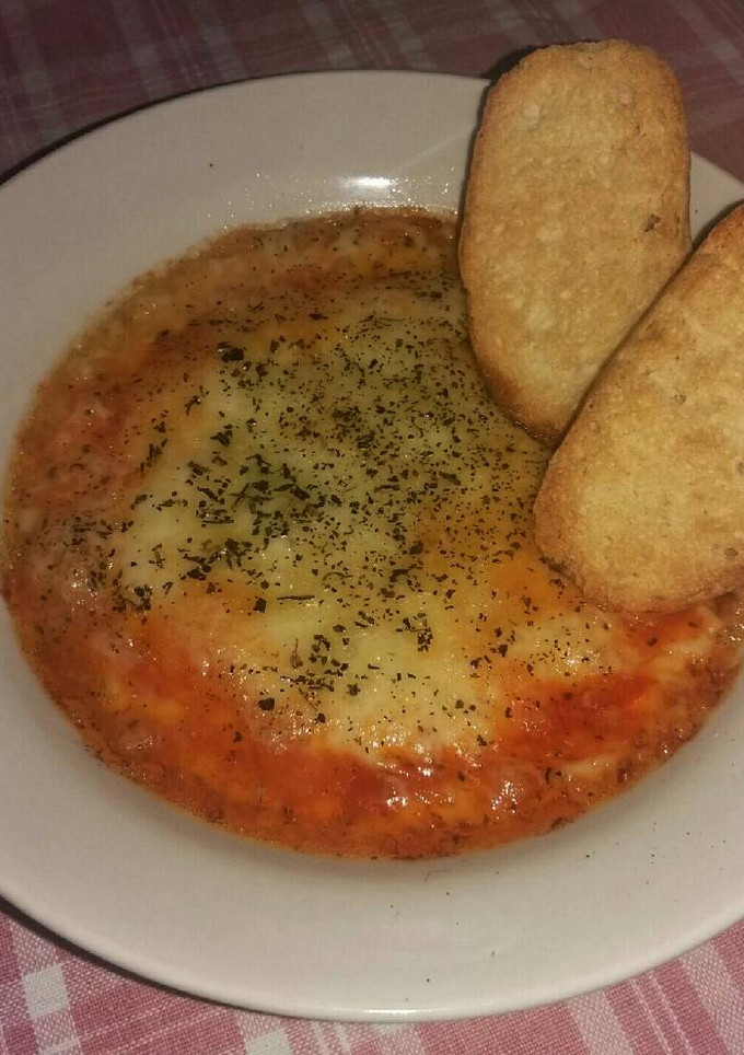 Una foto de Provolone al horno con tomate