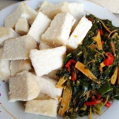 A picture of Boiled yam and vegetable ugba sauce.