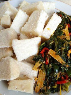 A picture of Boiled yam and vegetable ugba sauce.