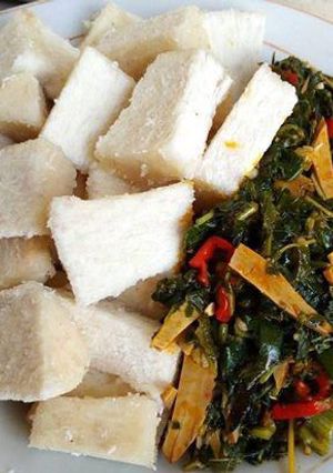 A picture of Boiled yam and vegetable ugba sauce.