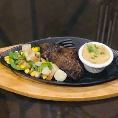 A picture of Steak with sauteed veg and potatoes.