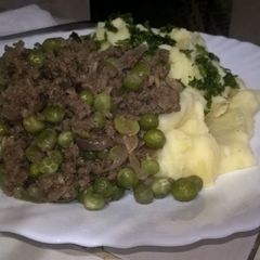 A picture of Mashed potatoes with minced meat and green peas stew.