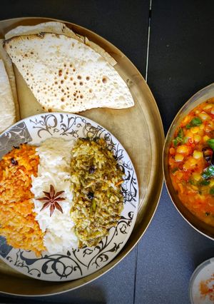 A picture of Tricolor pulav with bajri ki roti and dal palak.