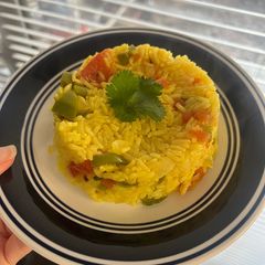 A picture of Yellow Rice with Jalapeños and Tomatoes.