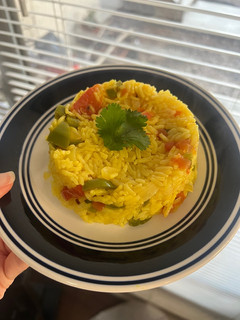 A picture of Yellow Rice with Jalapeños and Tomatoes.