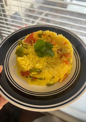 A picture of Yellow Rice with Jalapeños and Tomatoes.