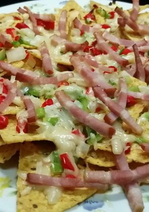 A picture of Mexican Nachos with Peppers, Onion, and Bacon.