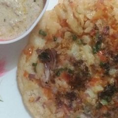 A picture of Coconut chutney uttapam.