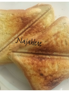 A picture of Toasted bread with butter and honey.