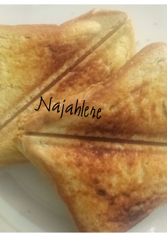 A picture of Toasted bread with butter and honey.