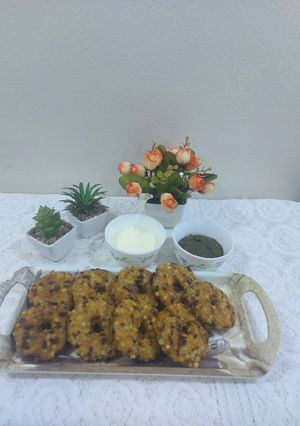 A picture of Sabudana vada donut with sweet curd and mint chutney.