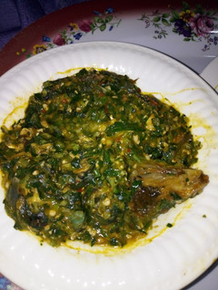 A picture of Okro soup with turkey and sea foods.