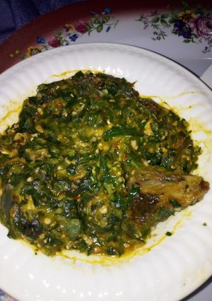 A picture of Okro soup with turkey and sea foods.