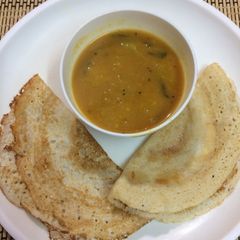A picture of Urad dal Lapsi dosa with toor dal pumpkin sambar.