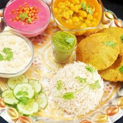 Punjabi Thali / Choley Puri, Boondi Raita, Beetroot Raita, Rice A picture of Punjabi Thali / Choley Puri, Boondi Raita, Beetroot Raita, Rice.