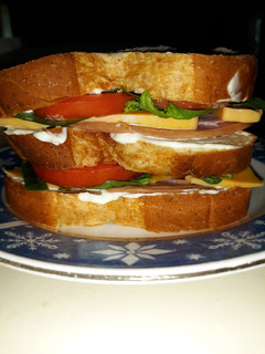 A picture of Delicous Triple Decker Ham Sandwich.