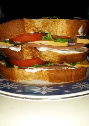 A picture of Delicous Triple Decker Ham Sandwich.