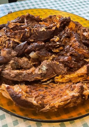 A picture of Marinated Braised Pork Shoulder with Tomatoes and Bacon.