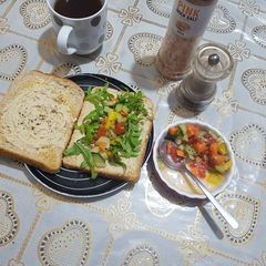 A picture of Humus sandwich with rocket and crunchy bright salad.