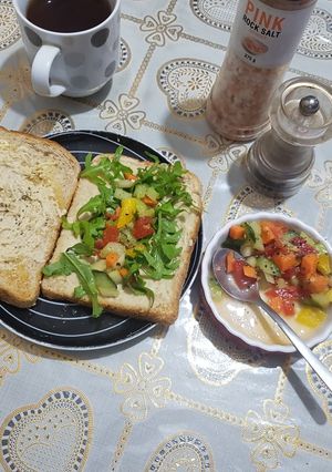 A picture of Humus sandwich with rocket and crunchy bright salad.