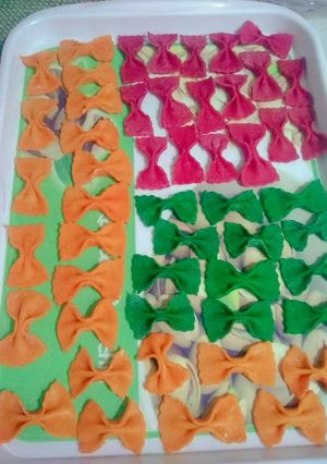A picture of Homemade farfalle pasta in three colour.